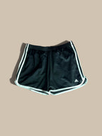 adidas Marathon 20 black running shorts with white 3-Stripes and a white logo on the lower right leg, displayed flat against a solid beige background.