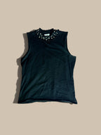 Carmen Marc Valvo black faux-pearl and rhinestone embellished knit shell, laid flat on a solid beige background.