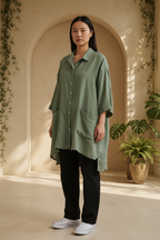 Eleven Stitch Design sage green asymmetrical snap-front pocket shacket modeled standing