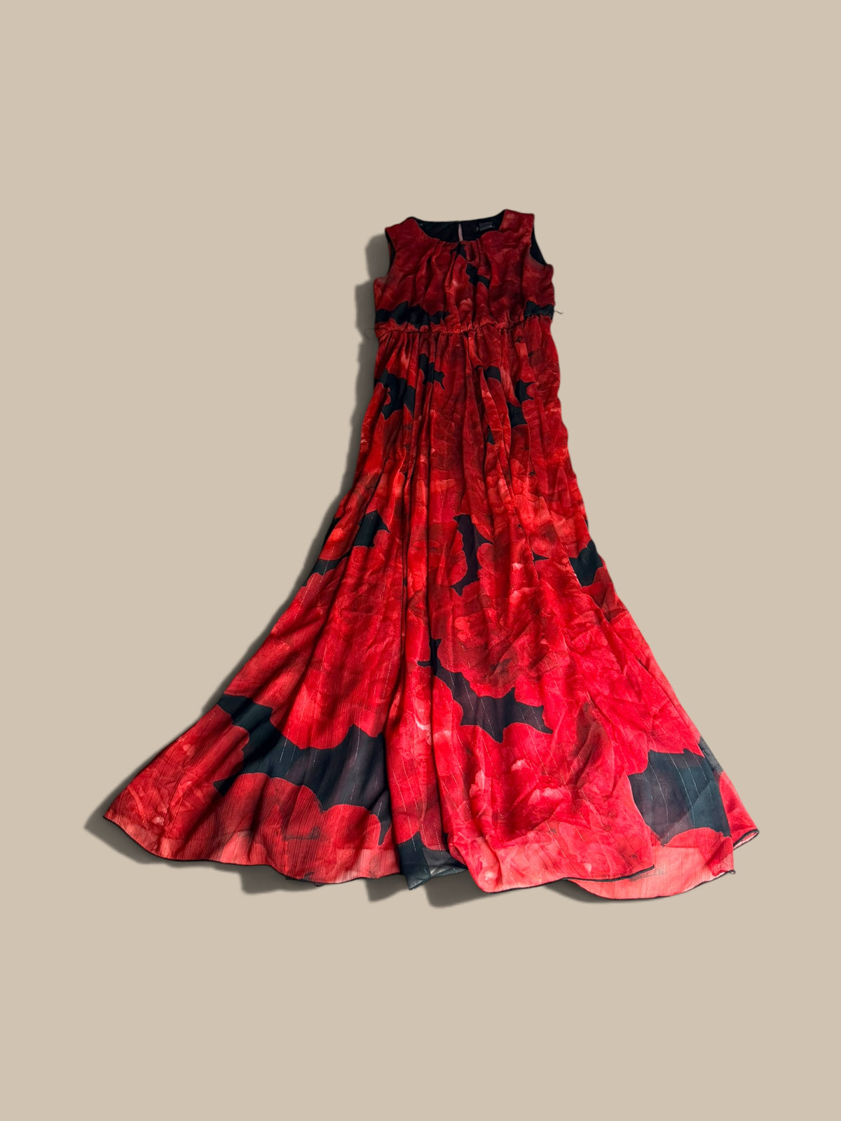 A sleeveless Enfocus Petite crimson red and black abstract floral chiffon maxi dress shown in a second full front flat lay, displayed against a solid beige background.