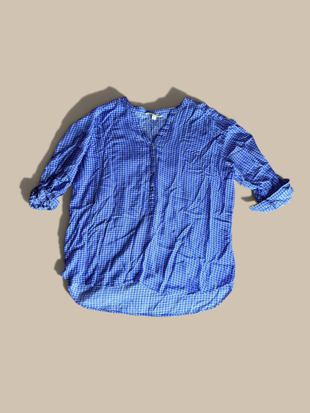 Grand & Greene royal blue and off-white geometric print high-low blouse shown in a front flat lay with relaxed sleeves