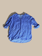 Grand & Greene royal blue and off-white geometric print high-low blouse shown in a front flat lay with relaxed sleeves