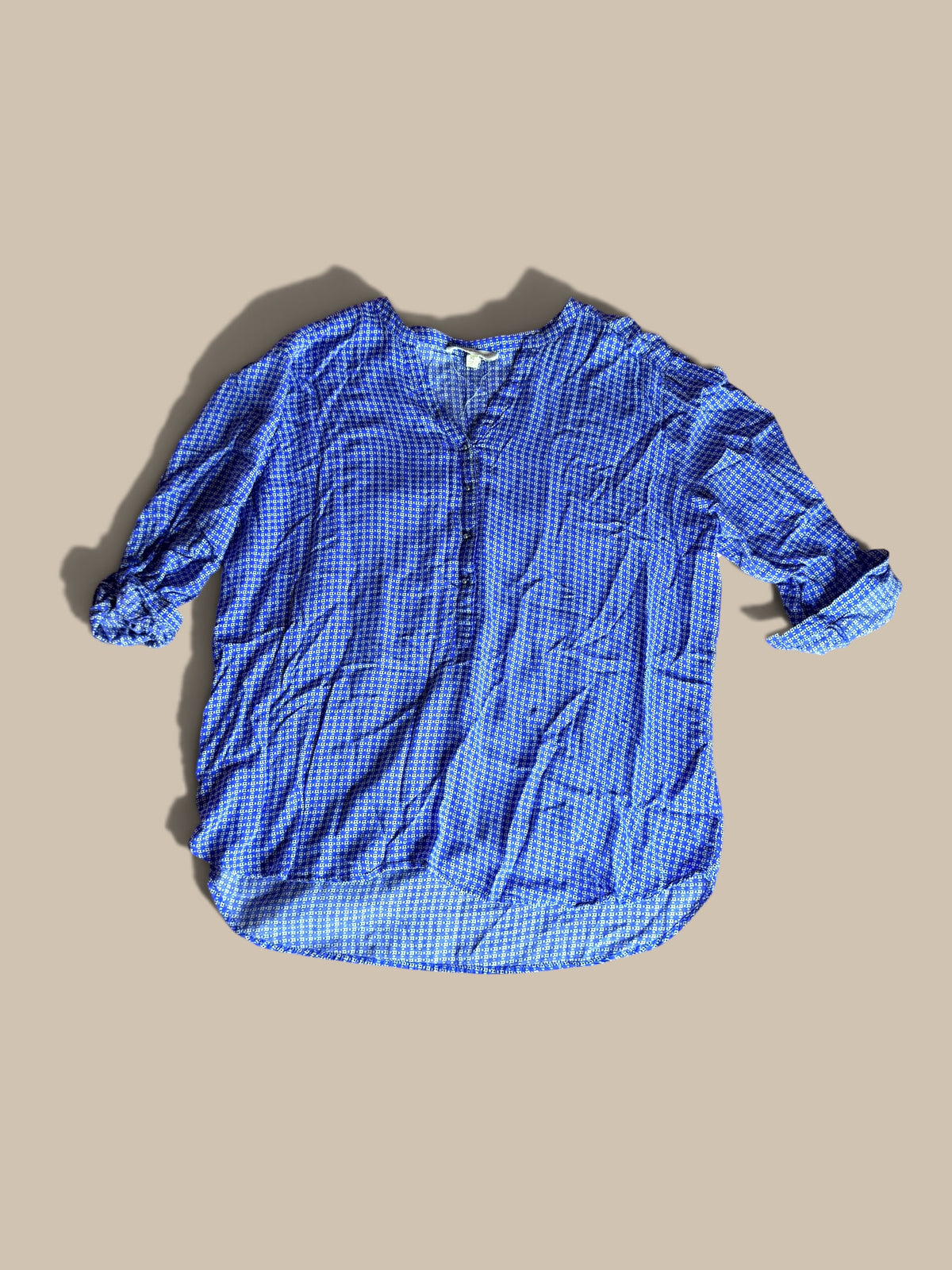 Grand & Greene royal blue and off-white geometric print high-low blouse shown in a front flat lay with relaxed sleeves