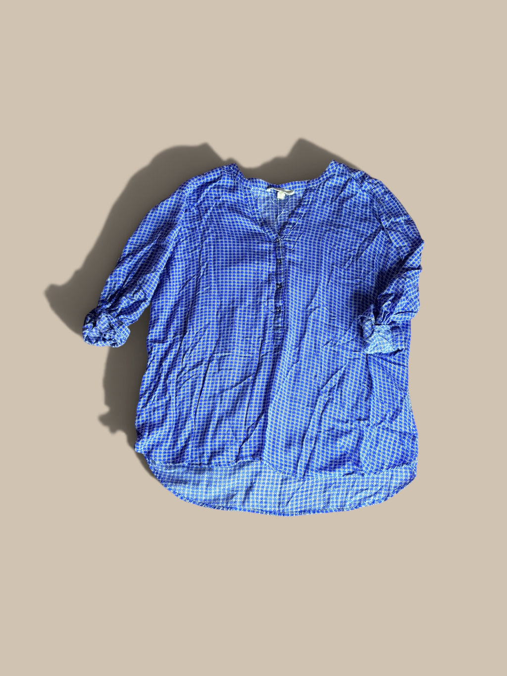 Grand & Greene royal blue and off-white geometric print high-low blouse shown in a front flat lay with right sleeve bent