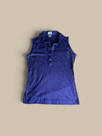 A sleeveless, Leon Levin deep purple indigo polo shirt shown in a second front flat lay.