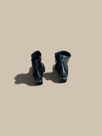 Nessa Samantha black ankle boots standing upright showing back view against a beige background.
