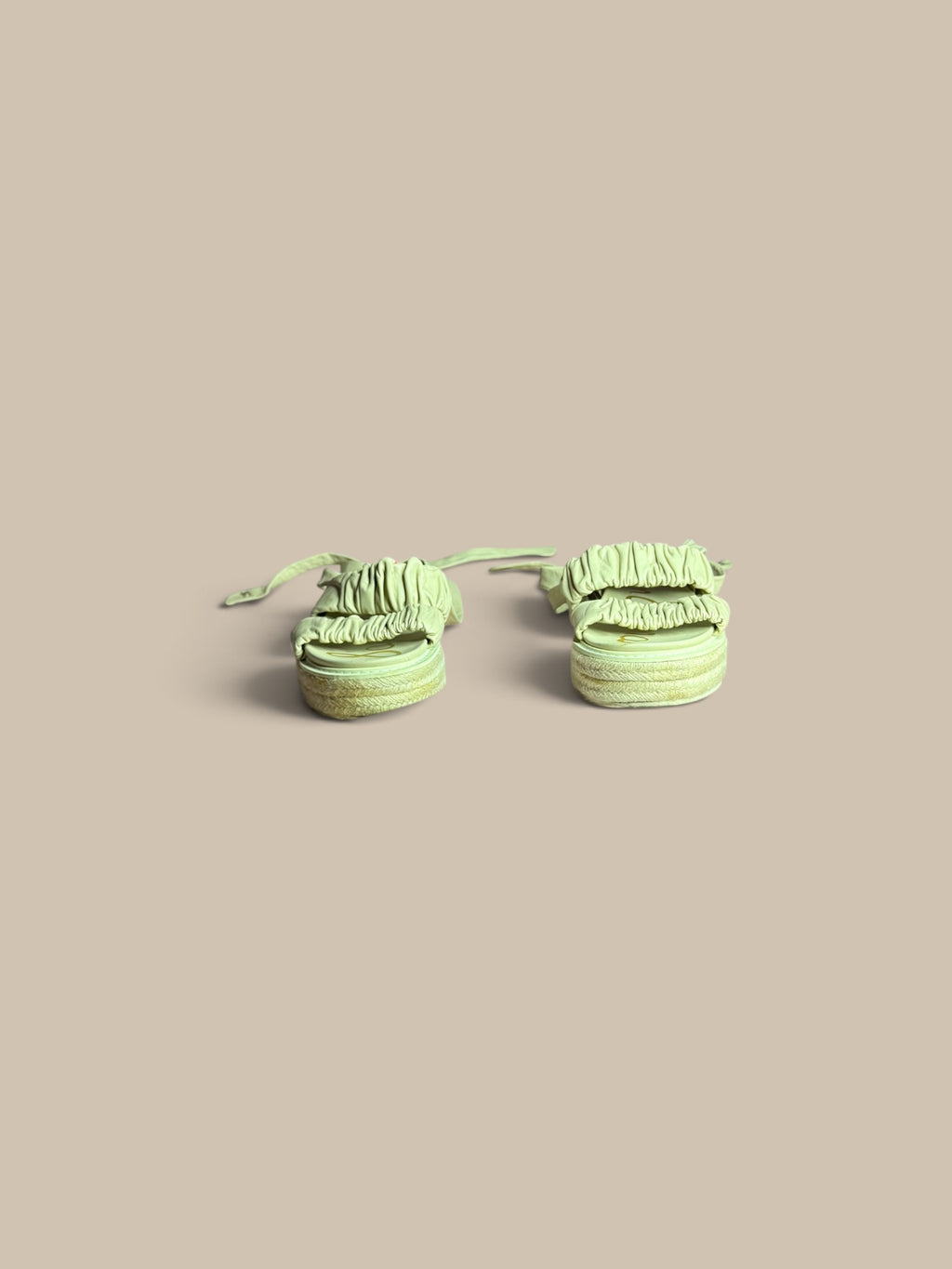 A pair of Sam Edelman Velma cream beige ruched espadrille sandals with fringed straps, shown on a solid beige background.
