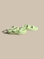 A pair of Sam Edelman Velma cream beige flatform espadrille sandals with wide straps and knotted bow details, displayed on a solid beige background.