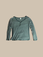A long-sleeve V-neck Stars Above charcoal grey and white striped Henley pajama, featuring a small button placket at the neckline, laid flat against a solid beige background.