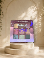 Makeup The Crème Shop Moonlit 9-color eyeshadow palette on a decorative stand.